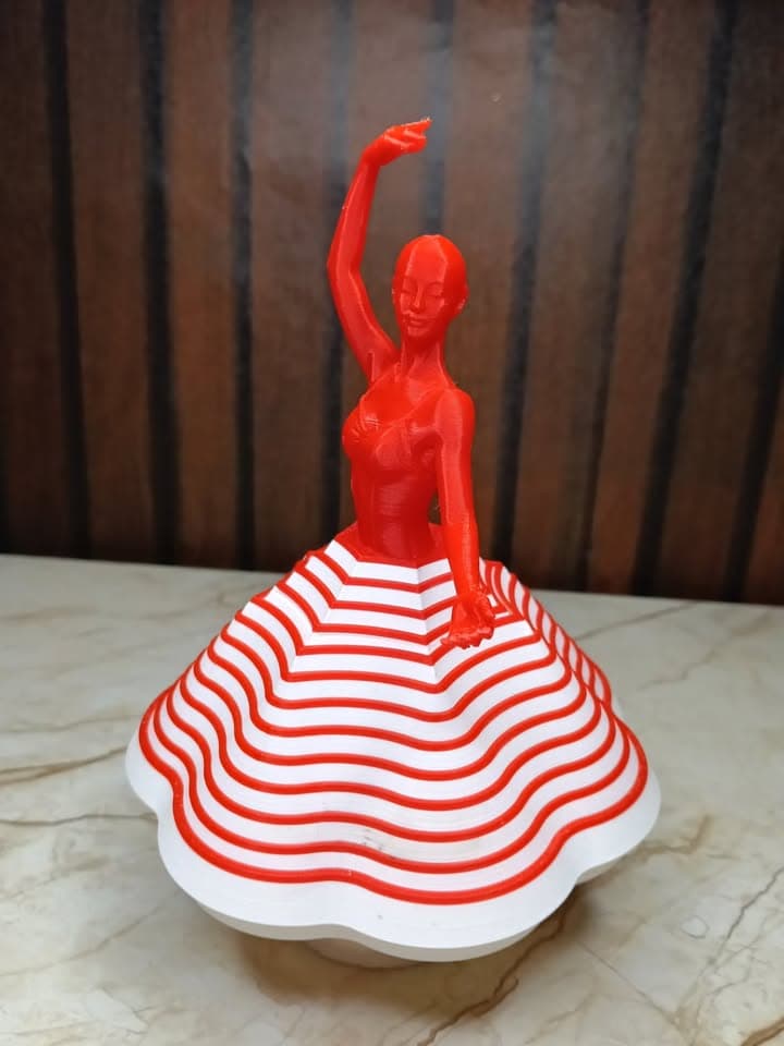 Close front view of a red-and-white 3D-printed dancer figurine